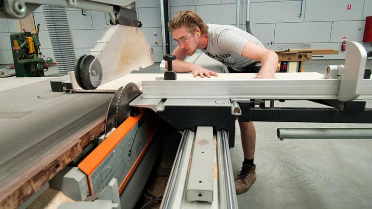 A cabinet maker using a panel saw