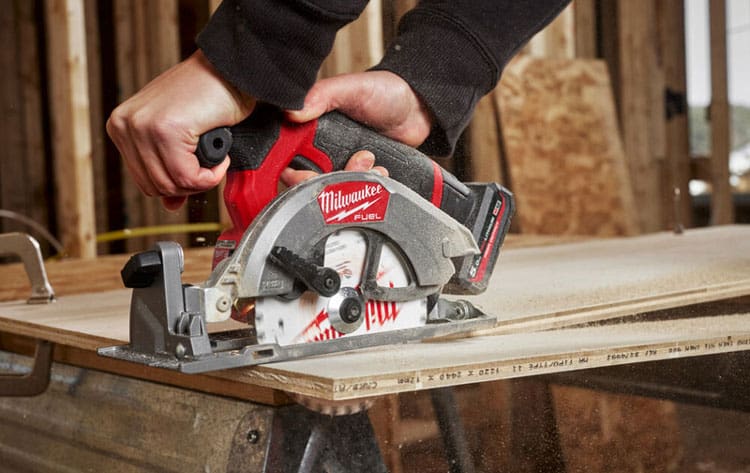 A cabinet maker cutting plywood with a circular saw