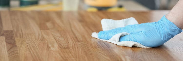 Applying a coat of oil to a wooden surface